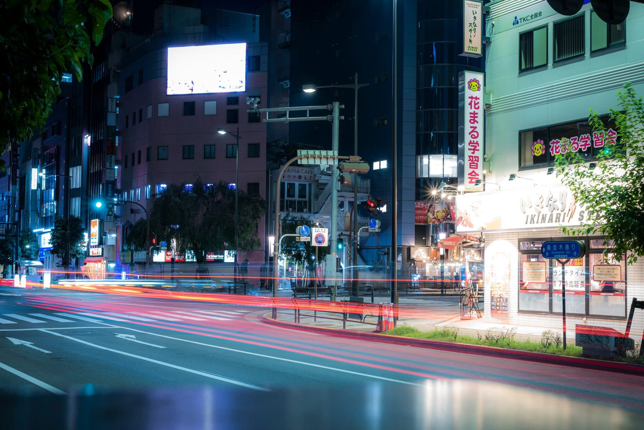 Car light trails streaking through a Hachioji junction at night