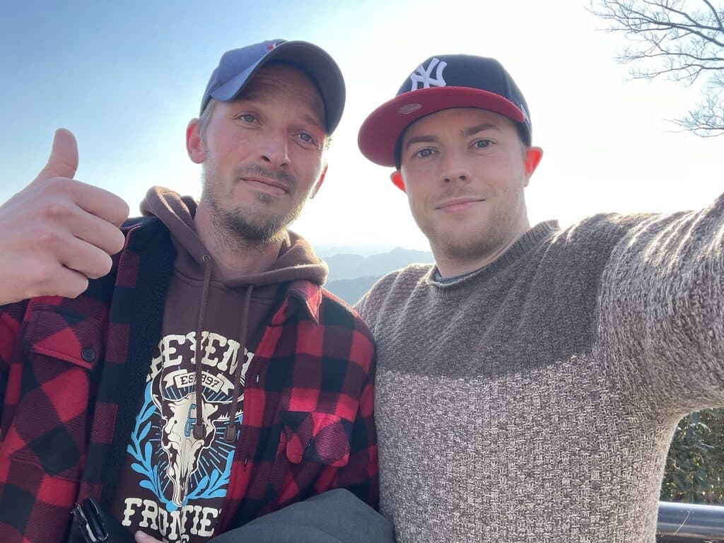 Luke and a friend giving a thumbs up on Takao's summit